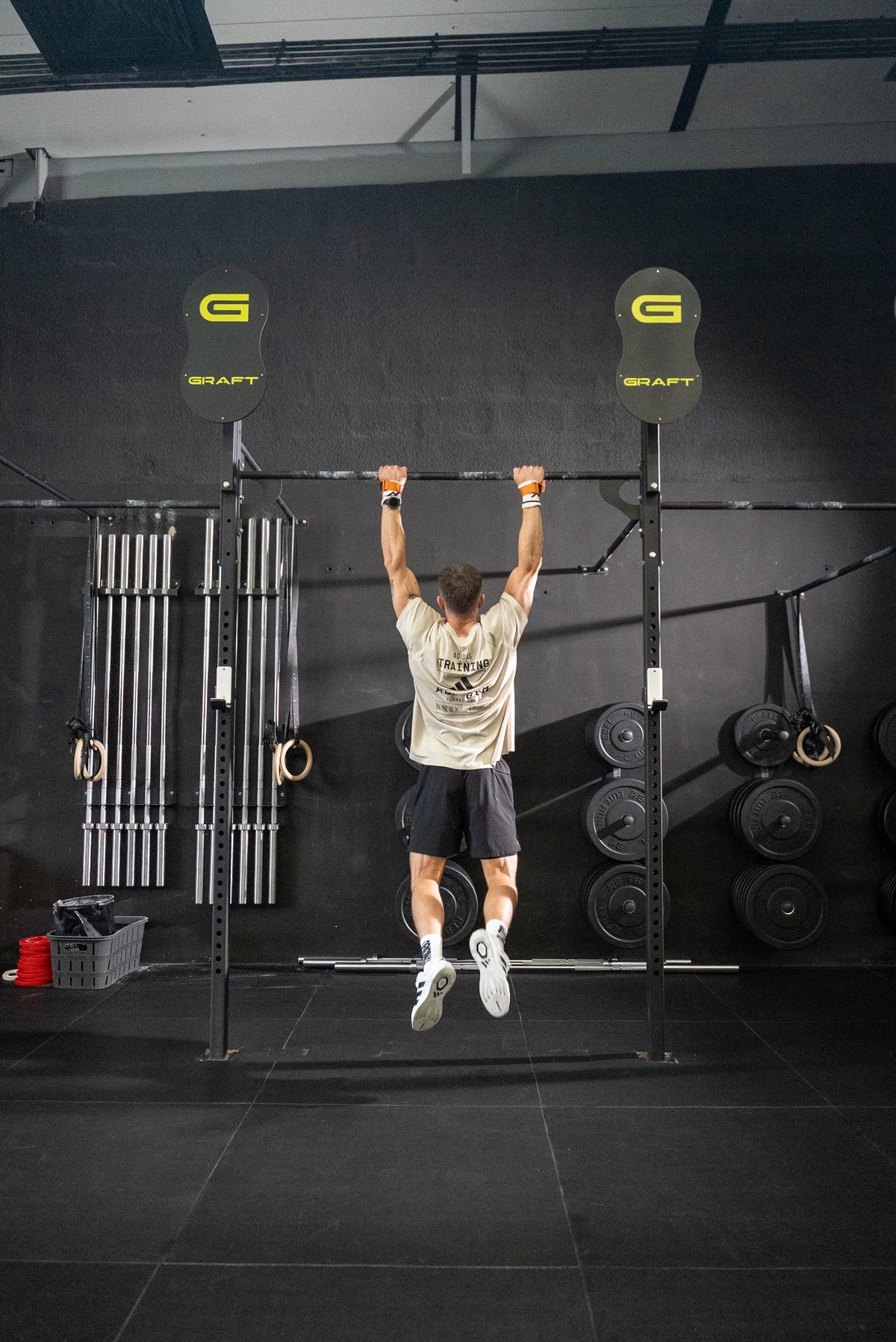 An athlete performing a tire-flip exercise, post-workout skin under real training stress.